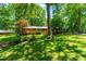 Charming single-Gathering home with a lush green lawn and mature trees providing ample shade at 5205 Rembert Dr, Raleigh, NC 27612