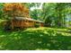 Charming single-Gathering home surrounded by lush greenery and mature trees, creating an inviting outdoor space at 5205 Rembert Dr, Raleigh, NC 27612