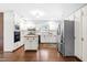 Traditional kitchen with white cabinetry, butcher block island, stainless steel refrigerator, and hardwood floors at 5205 Rembert Dr, Raleigh, NC 27612