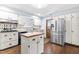 Charming kitchen featuring white cabinetry, stainless steel refrigerator, wood countertops, and hardwood floors at 5205 Rembert Dr, Raleigh, NC 27612