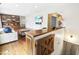 Open living space with hardwood floors features built-in shelving, a cozy couch, and a view of an adjacent room at 5205 Rembert Dr, Raleigh, NC 27612