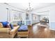 A beautiful seating area adjacent to the dining room shows great light and hardwood flooring at 5205 Rembert Dr, Raleigh, NC 27612
