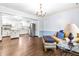 Sunlit living room with hardwood floors and an open layout, leading to a bright and functional kitchen at 5205 Rembert Dr, Raleigh, NC 27612