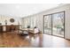 Sun-filled living room with hardwood floors, built-in cabinetry, large sliding doors to the outdoor space at 5205 Rembert Dr, Raleigh, NC 27612