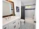 Clean bathroom with white vanity, patterned tile floor, and tub at 1208 New Grady Brown, Hillsborough, NC 27278