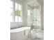 Elegant bathroom with a freestanding tub, large windows, and a glass-enclosed shower with marble surround at 1307 Mayfair Rd, Raleigh, NC 27608