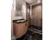 Modern bathroom with a glass shower, dark tile flooring, and a curved vanity at 1307 Mayfair Rd, Raleigh, NC 27608