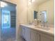 Modern bathroom with double vanity, light gray cabinets, and quartz countertop at 1307 Mayfair Rd, Raleigh, NC 27608