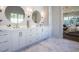 Bathroom with double vanity and view into bedroom at 1307 Mayfair Rd, Raleigh, NC 27608