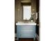 Chic bathroom vanity with a marble countertop, brass fixtures, and decorative sconces at 1307 Mayfair Rd, Raleigh, NC 27608