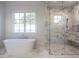 Bathroom with soaking tub and walk-in shower at 1307 Mayfair Rd, Raleigh, NC 27608