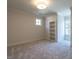 Bright bedroom with a built-in bookshelf, plush carpet, and a large window offering natural light at 1307 Mayfair Rd, Raleigh, NC 27608