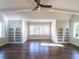 Spacious bedroom with hardwood floors, built-in shelving, and a large window at 1307 Mayfair Rd, Raleigh, NC 27608