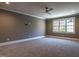 Spacious bedroom with gray walls, wall-to-wall carpet and a large window at 1307 Mayfair Rd, Raleigh, NC 27608