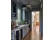Butler's pantry with a beverage center, custom cabinets, and designer lighting fixtures at 1307 Mayfair Rd, Raleigh, NC 27608