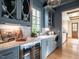 Butler's pantry with gray cabinets, marble countertops, and wine cooler at 1307 Mayfair Rd, Raleigh, NC 27608