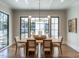 Elegant dining room with hardwood floors, large windows, and sliding glass doors at 1307 Mayfair Rd, Raleigh, NC 27608