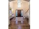 Two-story entryway with hardwood floors, chandelier, and staircase at 1307 Mayfair Rd, Raleigh, NC 27608