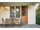 Outdoor dining area with table and chairs near the back door, set against a white siding exterior at 1307 Mayfair Rd, Raleigh, NC 27608
