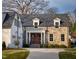 Charming stone and brick home featuring manicured landscaping and a concrete driveway at 1307 Mayfair Rd, Raleigh, NC 27608