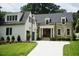 Beautiful home with a manicured lawn, stone facade, and inviting entrance at 1307 Mayfair Rd, Raleigh, NC 27608