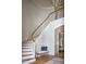 Elegant foyer features staircase, wooden banister and bench with view into the living room at 1307 Mayfair Rd, Raleigh, NC 27608