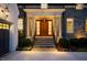 Close-up of the front door entrance framed by white columns, stonework, and manicured landscaping at 1307 Mayfair Rd, Raleigh, NC 27608