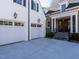 Two-car garage with white doors and lanterns, attached to the home at 1307 Mayfair Rd, Raleigh, NC 27608