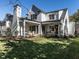 White two-story house with a large backyard and covered patio at 1307 Mayfair Rd, Raleigh, NC 27608