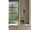 Stylish kitchen showcasing white countertops, grey subway tile, and window view at 1307 Mayfair Rd, Raleigh, NC 27608