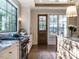 Bright kitchen features a gas range, custom cabinetry, and French doors to backyard at 1307 Mayfair Rd, Raleigh, NC 27608