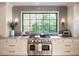 Gourmet kitchen with Wolf range, gray tile backsplash, and marble counters at 1307 Mayfair Rd, Raleigh, NC 27608