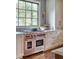 Gourmet kitchen features stainless steel Wolf appliances and a window view at 1307 Mayfair Rd, Raleigh, NC 27608