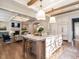 Open concept kitchen with large island, hardwood floors, and Gathering room view at 1307 Mayfair Rd, Raleigh, NC 27608