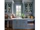Chic butler's pantry featuring blue cabinets with marble counters, wine fridge, and stainless steel microwave at 1307 Mayfair Rd, Raleigh, NC 27608