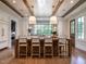 Modern kitchen with large island, white cabinets, and wood flooring at 1307 Mayfair Rd, Raleigh, NC 27608