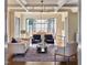 Sunlit living room with hardwood floors, decorative ceiling and view into dining area at 1307 Mayfair Rd, Raleigh, NC 27608