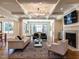 Spacious living room with fireplace, hardwood floors, and large windows at 1307 Mayfair Rd, Raleigh, NC 27608