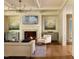 Elegant living room featuring a fireplace, coffered ceiling, and hardwood floors at 1307 Mayfair Rd, Raleigh, NC 27608