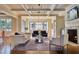 Cozy living room features hardwood floors, coffered ceiling and fireplace with marble surround at 1307 Mayfair Rd, Raleigh, NC 27608