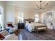 Spacious main bedroom featuring hardwood floors, sitting area, and designer lighting at 1307 Mayfair Rd, Raleigh, NC 27608