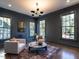 Dark-walled sitting room with hardwood floors and plenty of natural light at 1307 Mayfair Rd, Raleigh, NC 27608