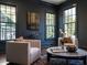 Sophisticated sitting room with dark walls, hardwood floors, and comfortable seating at 1307 Mayfair Rd, Raleigh, NC 27608