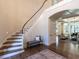 Curved staircase with hardwood treads and white railing at 1307 Mayfair Rd, Raleigh, NC 27608