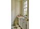 Powder room featuring stone countertops, custom cabinets, and an undermount sink at 1307 Mayfair Rd, Raleigh, NC 27608