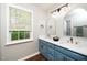 Double vanity bathroom with blue cabinets and gold fixtures at 1554 Middle Ridge Dr, Willow Springs, NC 27592