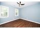 Well-lit bedroom with dark brown hardwood floors at 1554 Middle Ridge Dr, Willow Springs, NC 27592
