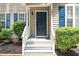Inviting front entry with blue door and white railings at 1554 Middle Ridge Dr, Willow Springs, NC 27592