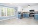 Modern kitchen with blue and white cabinets, stainless steel appliances at 1554 Middle Ridge Dr, Willow Springs, NC 27592