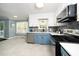 Updated kitchen with stainless steel appliances and blue cabinets at 1554 Middle Ridge Dr, Willow Springs, NC 27592